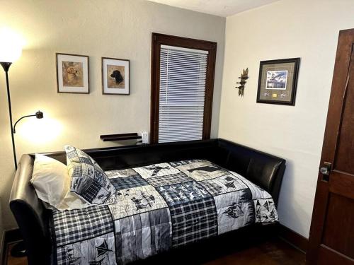 ein Schlafzimmer mit einem Bett mit einer Decke darauf in der Unterkunft The Great River Retreat in New Albin