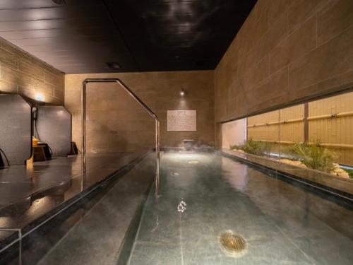 a swimming pool in the middle of a building at Super Hotel Yamaguchi Yuda Onsen in Yamaguchi