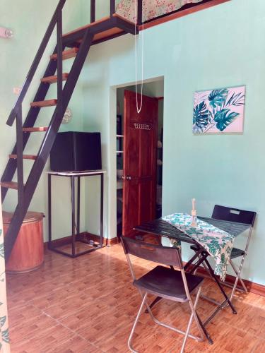 a dining room with a table and a staircase at Nueva Villa Paraíso Four Villas in Lagunillas