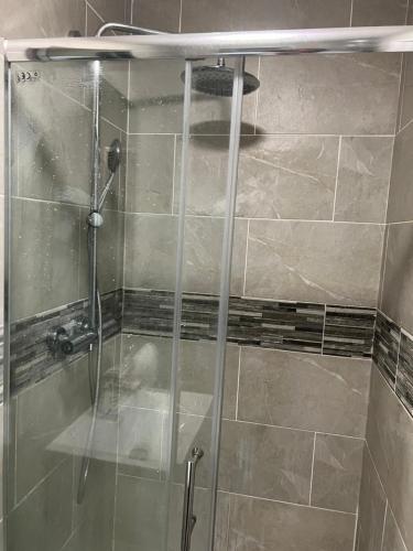 a shower with a glass door in a bathroom at HAMS REST PLACE - Strictly Only ONE GUEST ALLOWED IN ONE ROOM A SECOND ACCOMPANYING PERSON WILL NOT BE ALLOWED INTO THE PROPERTY in Birmingham