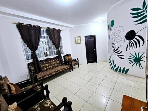 a living room with a couch and a window at Departamento amoblado excelente para familias in Puerto Baquerizo Moreno