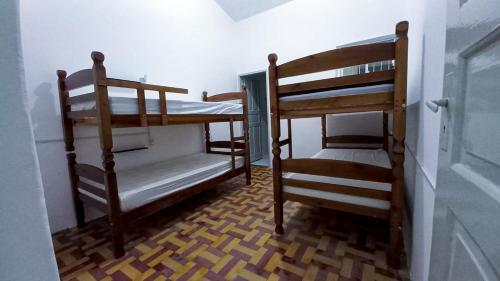 a room with two bunk beds and a staircase at Yolo Hostel in João Pessoa