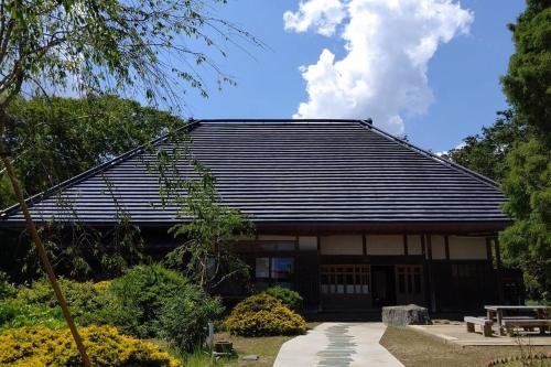a japanese house with a black roof at 古民家の宿Traditional Japanese folk house in Hasunuma
