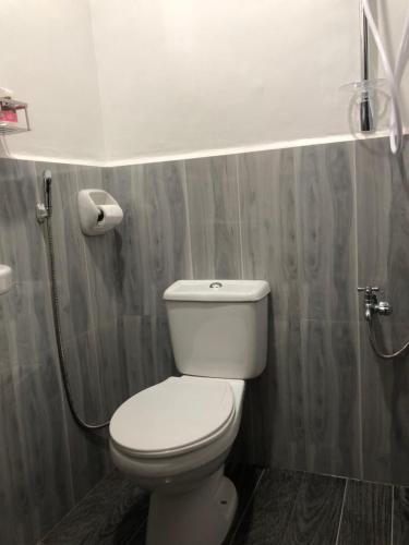 a bathroom with a white toilet and a shower at Hello Hostel in San Vicente