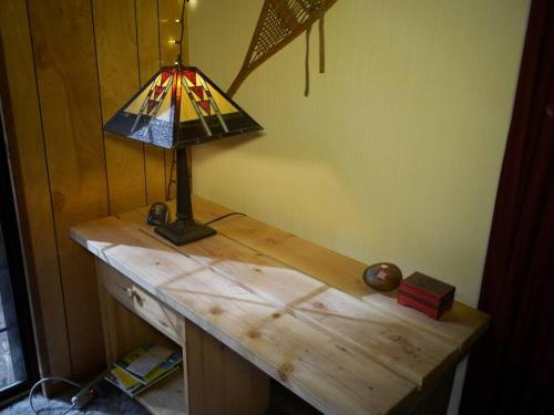 a lamp on top of a wooden desk at Sweet Retreat: Theater, Pool/Ping-Pong, Quiet! in Camp Connell