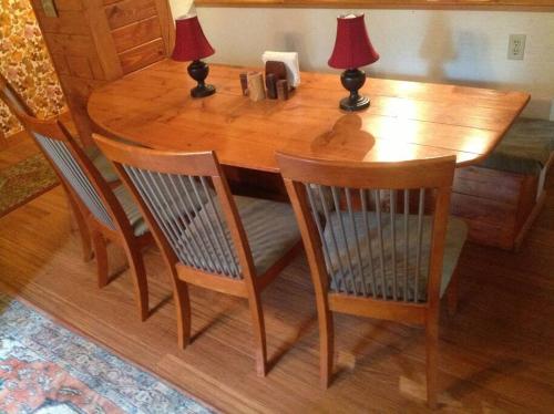 a wooden table with two lamps and two chairs at Sweet Retreat: Theater, Pool/Ping-Pong, Quiet! in Camp Connell