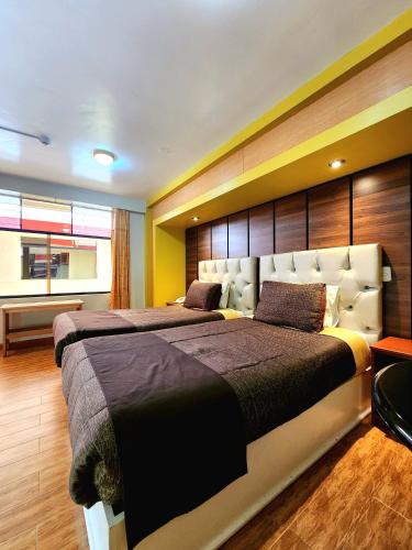 a bedroom with two beds in a room at El Mariscal Cusco in Cusco