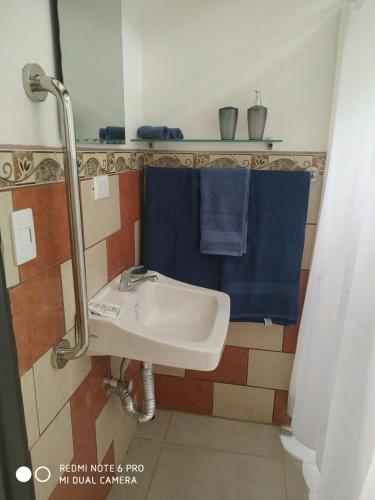 a bathroom with a sink and a blue towel at Villa Zurí in Guanacaste