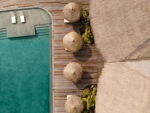 an overhead view of a swimming pool and some ottomans at Menjaga Bay in Labuan Bajo