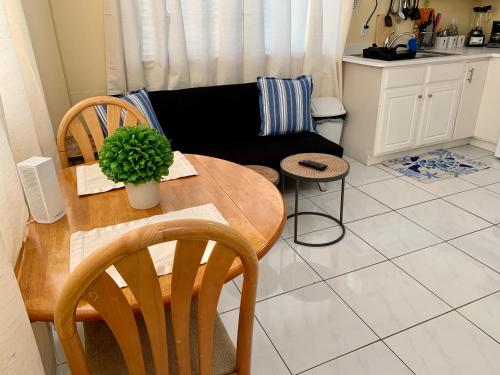 a living room with a table and a couch at 3 SUITES AT BLUE PAVILION - 3 Apartments, 3 Kitchens - Steps to BEACH in West Bay
