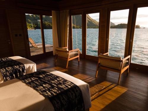 a room with two beds and a view of the water at Menjaga Bay in Labuan Bajo