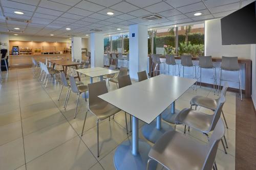 a conference room with tables and chairs and a podium at City Express by Marriott Manzanillo in Manzanillo