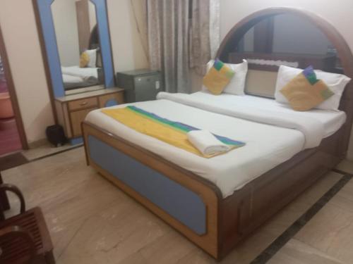 a bedroom with a bed with a large mirror at HOTEL MERCURY 50 STEP FROM DARBAR SAHIB in Amritsar