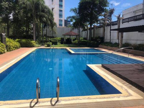a swimming pool with blue water in a building at 3 Beds Filinvest Alabang in Manila