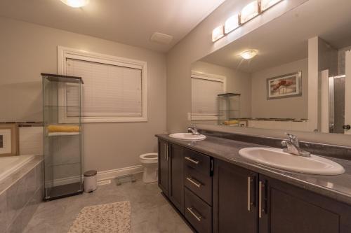 a bathroom with two sinks and a shower and a toilet at SABAA in Ottawa