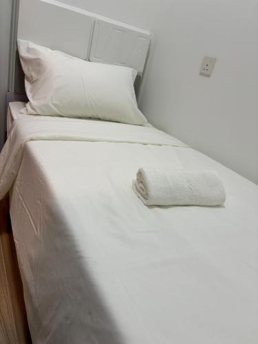 a white bed with white sheets and pillows at Ataraxia park condo forest city in Gelang Patah