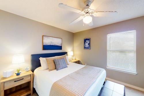 a bedroom with a bed and a ceiling fan at Grand Caribbean East & West W310 in Perdido Key