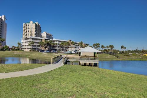 a walkway next to a body of water with buildings at Grand Caribbean East & West W310 in Perdido Key