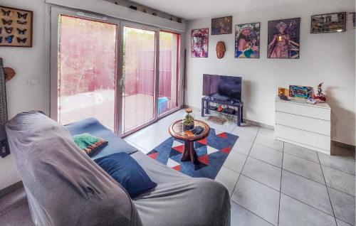 a living room with a couch and a table at 3 Bedroom Gorgeous Home In Agde in Agde