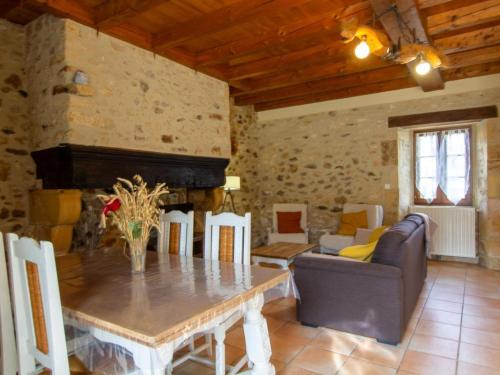 un salon avec une table et un canapé dans l'établissement Maison avec jacuzzi partagé, jardin et garage près de Monpazier - FR-1-616-87, à Saint-Avit-Rivière