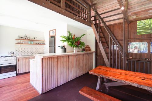 a kitchen with wooden walls and a wooden bench at Noah Creek Eco Huts in Cape Tribulation
