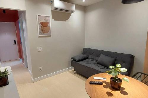 a living room with a couch and a table at Loft Dream Rest II in Teresópolis