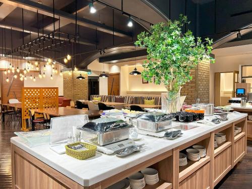 a restaurant with a counter with dishes on it at Garden Hotel Shizuoka in Shizuoka