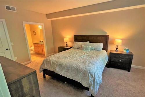 a bedroom with a bed with two night stands and two lamps at 3-Bedroom Luxury Condo in the Heart of the City in Salt Lake City