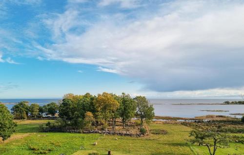 a field with trees and a body of water at Gorgeous Home In Jämjö With Kitchen in JÃ¤mjÃ¶