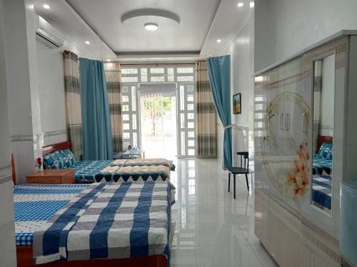 a bedroom with two beds in a room with a window at 18 Homestay Star's in Can Tho