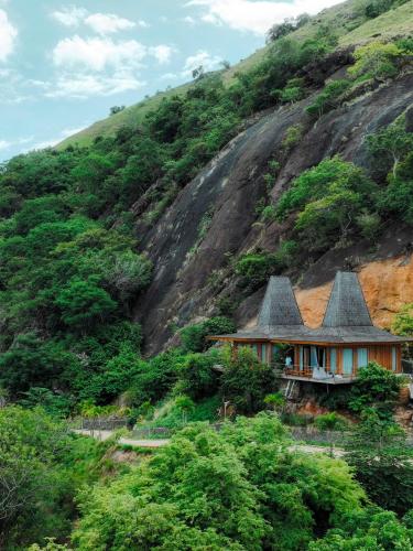a house on the side of a mountain at Menjaga Bay in Labuan Bajo