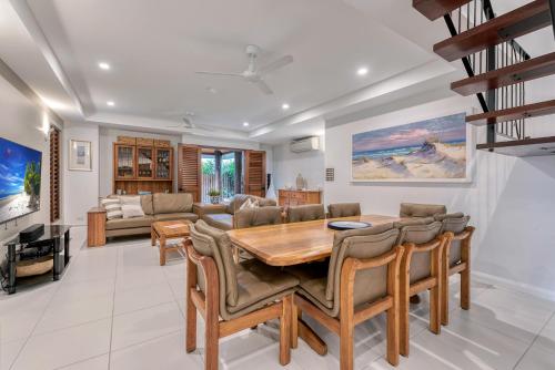 a dining room with a table and chairs at Villa 3 @ Chez Willow, 2 mins to Four Mile Beach in Port Douglas