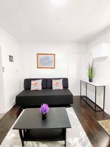 a living room with a couch and a table at Guesthouse in Suva in Suva
