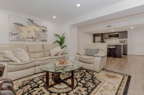 a living room with a couch and a table at Luxury Basement Apartment in Oakville Monthly stays only in Oakville