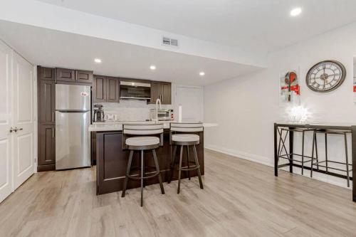 a kitchen with a counter and some stools in it at Luxury Basement Apartment in Oakville Monthly stays only in Oakville