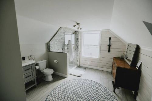 a bathroom with a sink and a toilet and a desk at Ultimate Relaxation Heritage Charmer in Vernon