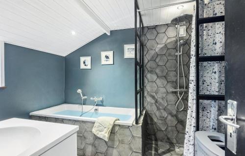 a bathroom with a tub and a sink and a shower at Lovely Home In Bogense With Wifi in Bogense