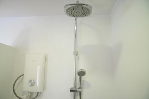 a shower with a shower head in a bathroom at One Beach Resort By EHM in Koh Rong Sanloem