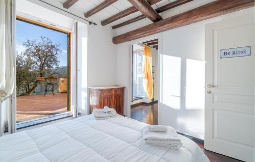 a bedroom with a large bed and a large window at Stunning Apartment In Recco With Outdoor Swimming Pool, 1 Bedrooms And Wifi in Recco