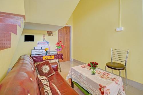 een woonkamer met een bank en een tafel bij OYO Shirdi Sai Guest House in Kamakhya