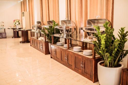 a buffet line with plates and dishes on display at Royal ANAN Hotel in Ninh Binh
