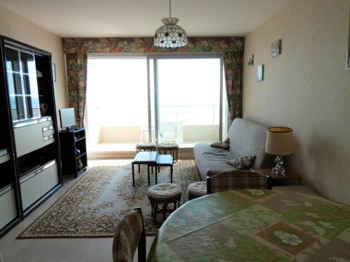 un salon avec un canapé et une table dans l'établissement Studio cabine bord de mer avec balcon et parking privé - FR-1-323-421, à Saint-Jean-de-Monts