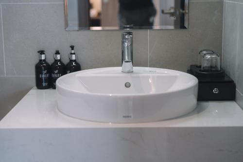 a white sink with a faucet in a bathroom at Canary Dalat Hotel in Da Lat