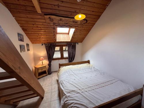 a bedroom with a bed and a wooden ceiling at Appartement Vars, 2 pièces, 6 personnes - FR-1-773-5 in Vars