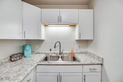 a kitchen with white cabinets and a sink at Grand Junction Vacation Rental Near University! in Grand Junction
