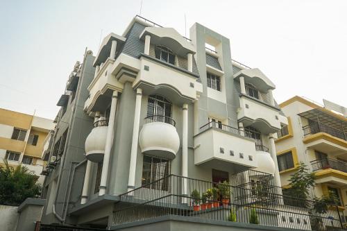 a white building with balconies on the side of it at Super Collection O D'Villa in Pune