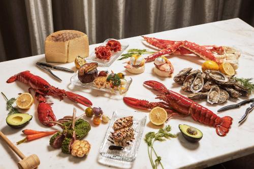 a table with seafood and other foods on it at The St. Regis Bangkok in Bangkok