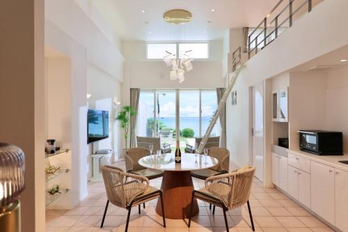 a kitchen and dining room with a table and chairs at Crystal Villa Miyakojima Sunayama Beach in Miyako-jima