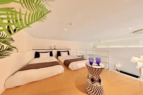two beds in a room with two at Crystal Villa Miyakojima Sunayama Beach in Miyako Island