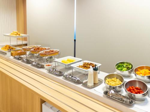 a buffet with many different types of food on it at Hotel Wing Port Nagasaki in Nagasaki